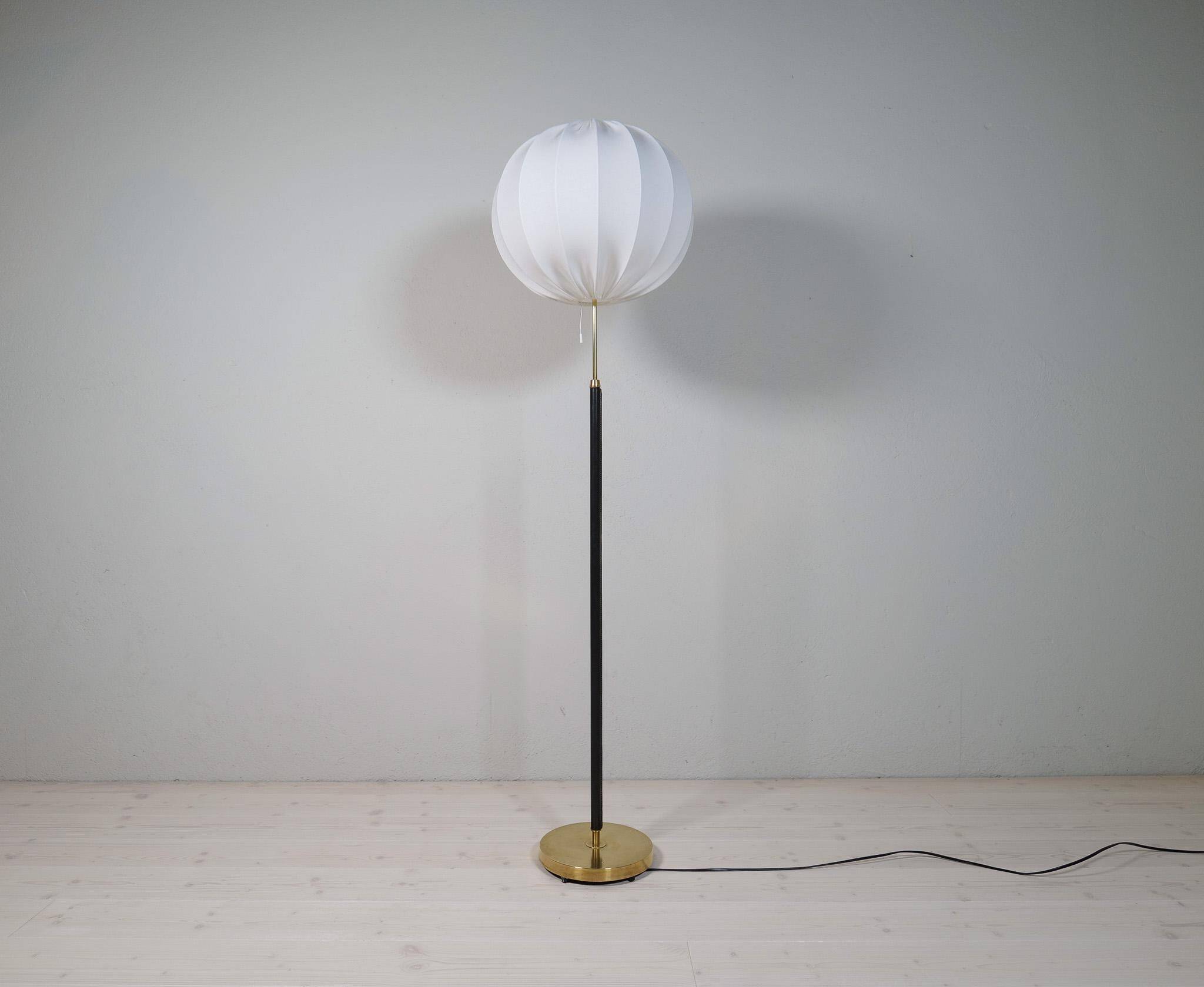 Mid-century black leather and brass floor lamp by Falkenbergs Belysning, Sweden, 1960s.