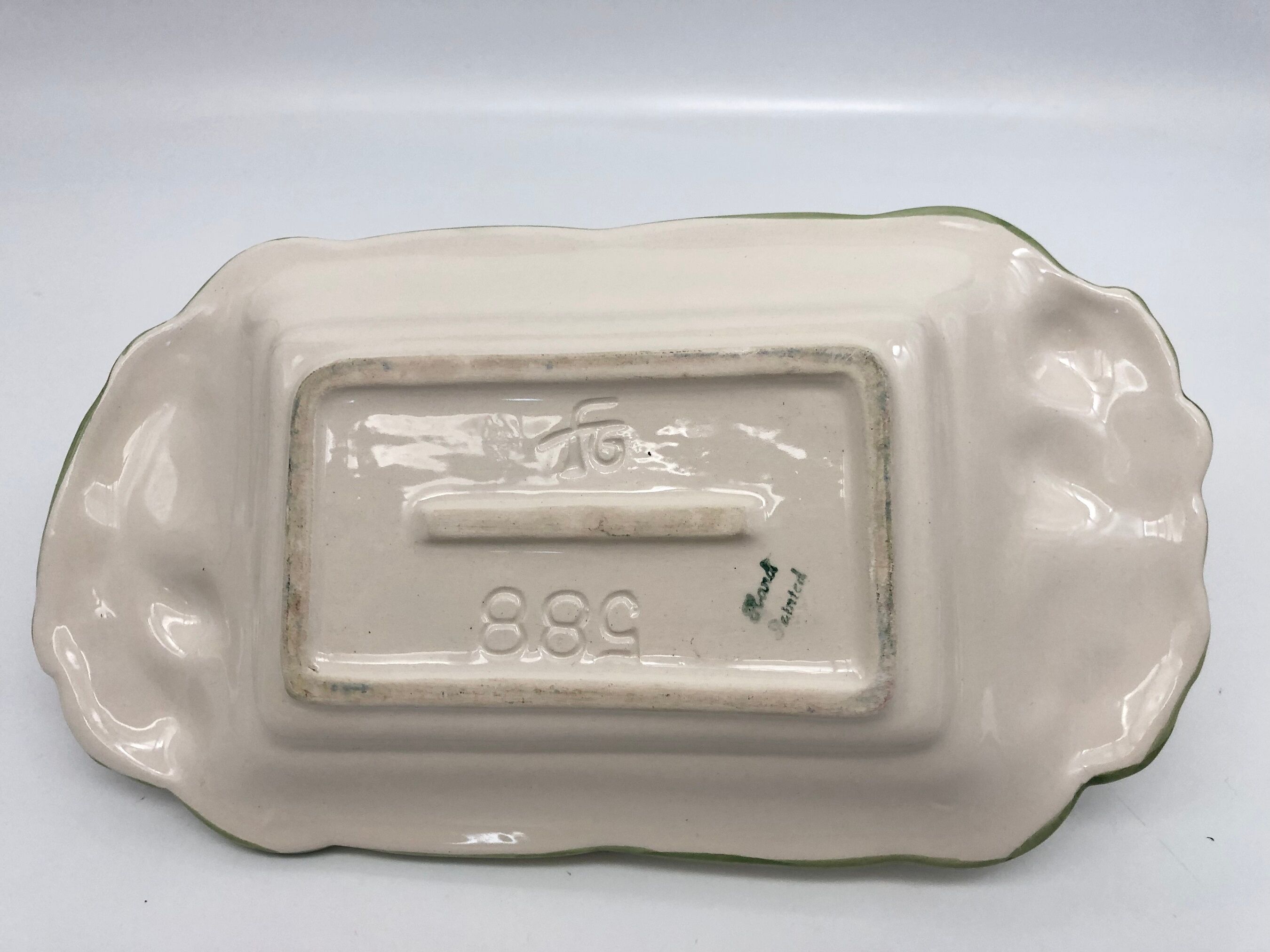 Slurry butter dish, with radish drawings. Signed "FG"