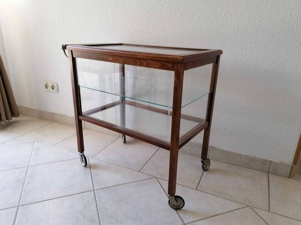 Art Deco brown wooden and glass bar cart, mobile display cabinet from the 1950s.