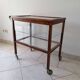Art Deco brown wooden and glass bar cart, mobile display cabinet from the 1950s.