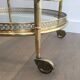 Round brass rolling table attributed to Maison Jansen