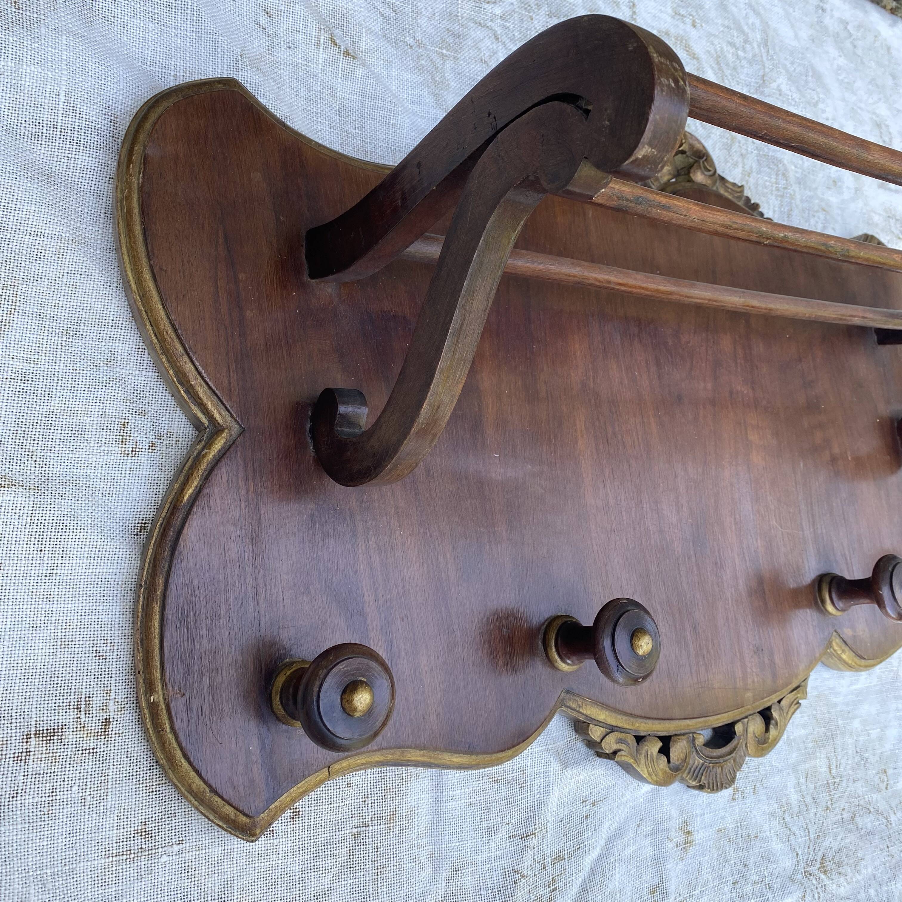 Coat rack and wall-mounted hat rack in an antique style.