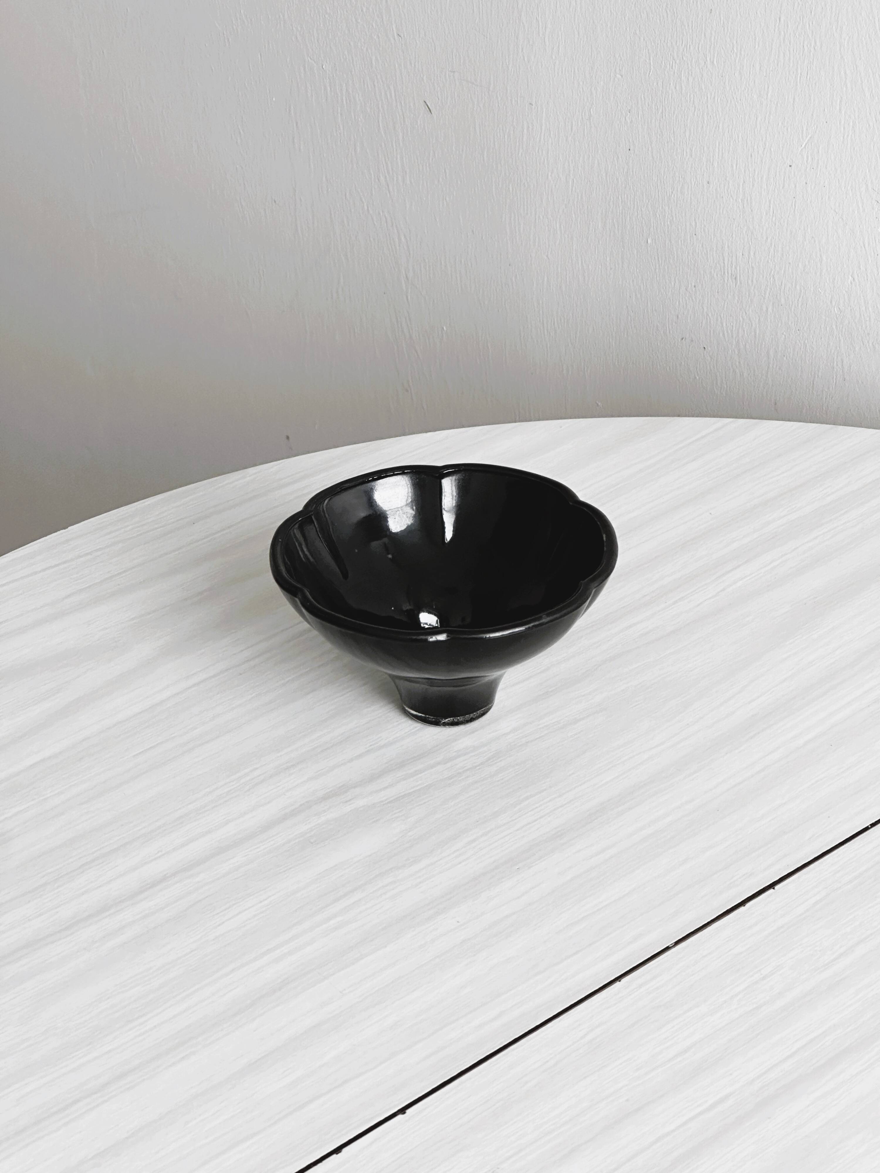 Small black glass cup
