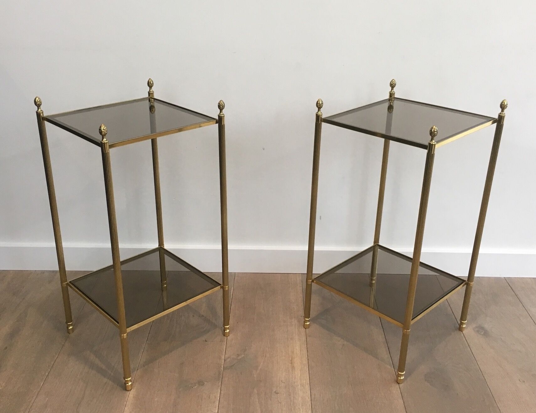 Pair of neoclassical style sofa ends in gilded metal and glass