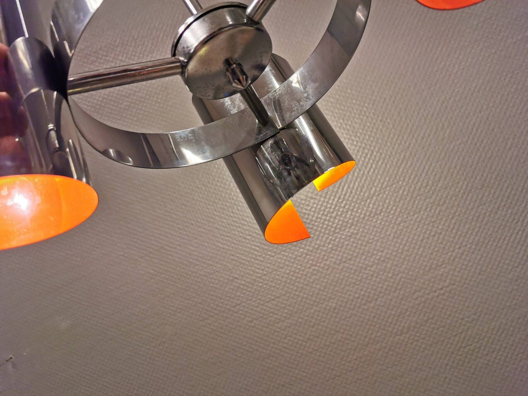 Hanging lamp in chromed metal with orange contrast lacquer and three light sources.