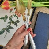 Corn and silver metal salad cutlery