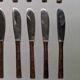 Set of 12 bamboo-style dessert knives in brass.