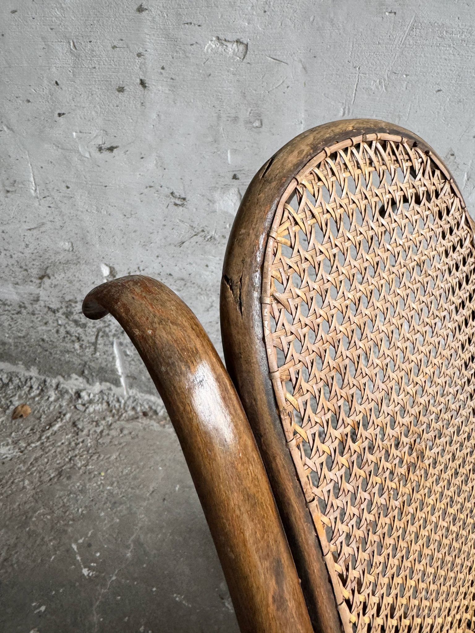 Warm walnut bentwood and cane child's rocking chair early 20th-century
