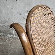 Warm walnut bentwood and cane child's rocking chair early 20th-century