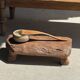 Small stool, footrest in blond teak, organic monoxyle with cut corners.