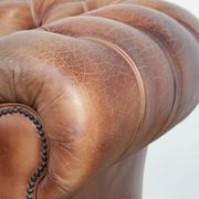 Chesterfield armchair in English style made of cowhide leather