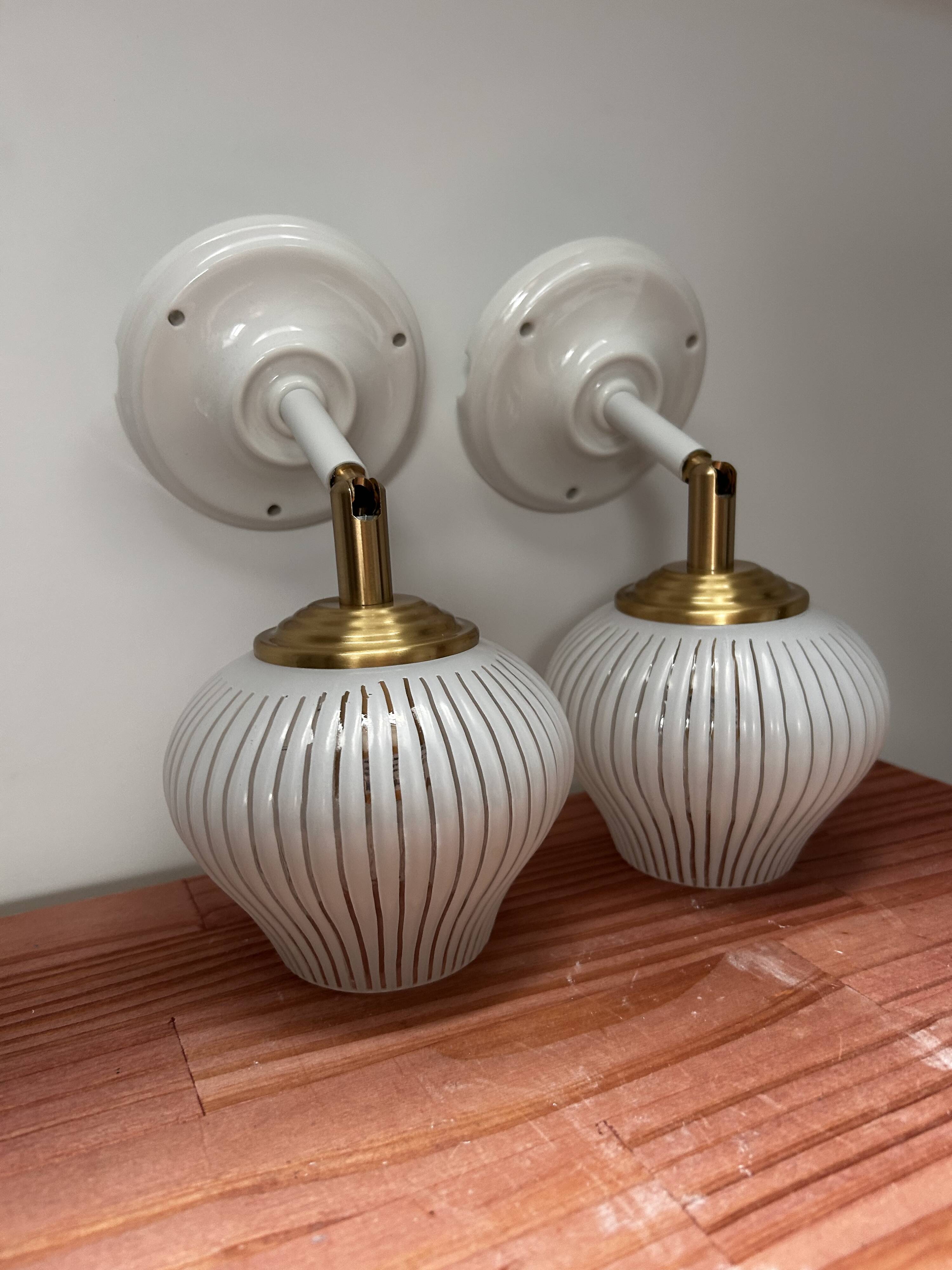 Pair of vintage white globe tilting wall sconces