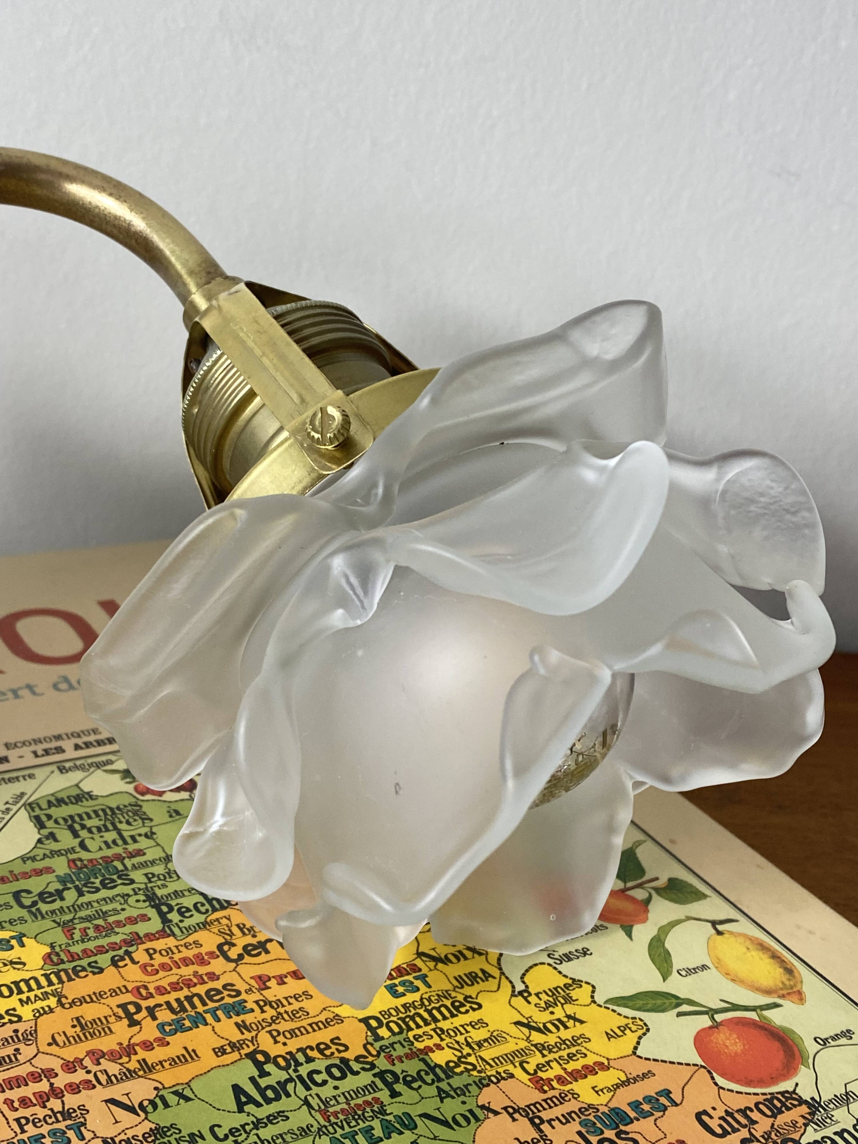 Swan neck wall light in brass with rose petal glass shade.