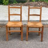 2 solid wood and straw chairs
