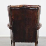 Cognac-colored vintage sheep leather wingback chair with character