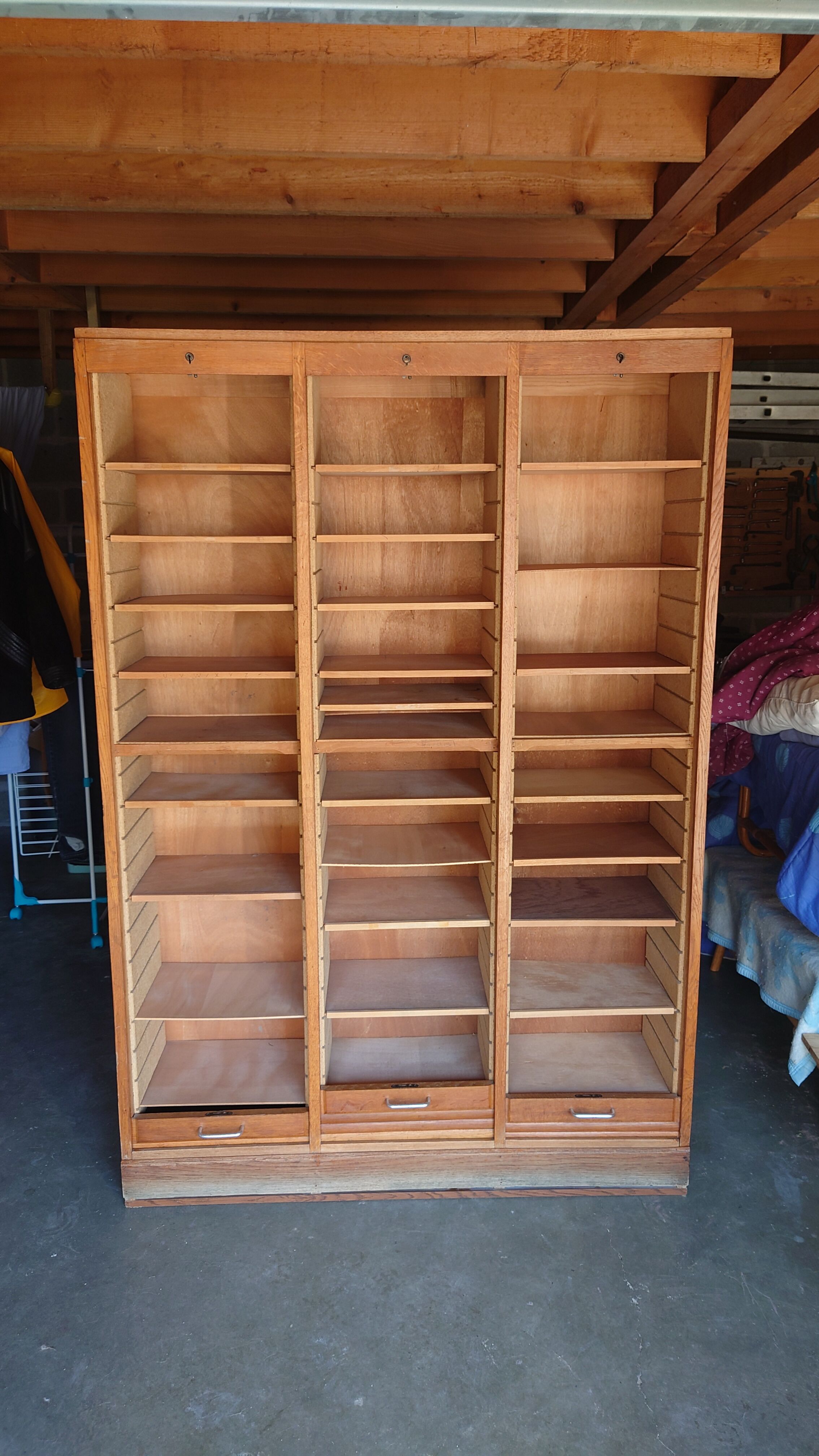 Filing cabinet has curtains, notary furniture. 3 columns