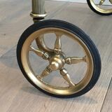 Neoclassical style rolling table in brass with blue glass tops