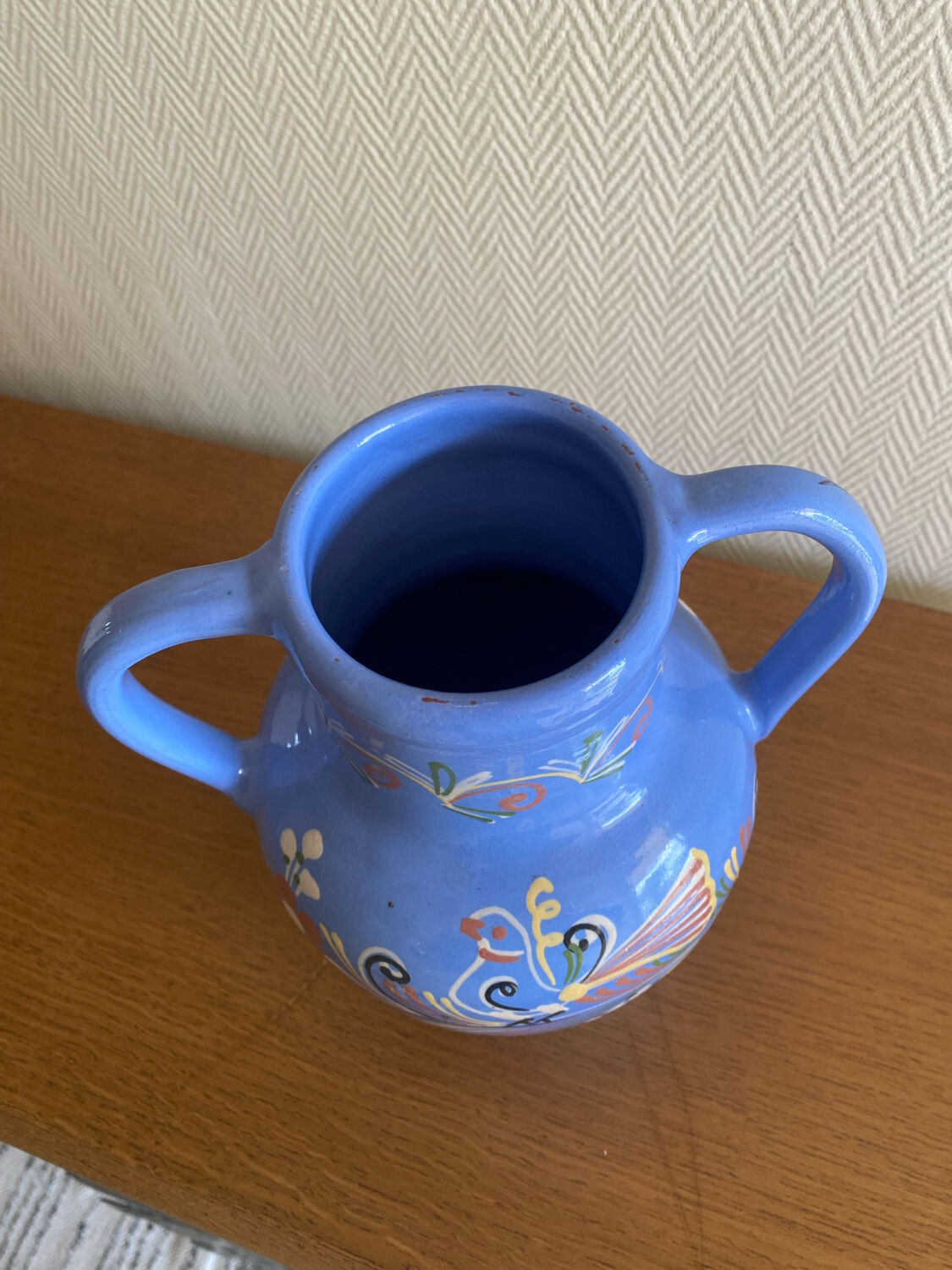 Glazed blue ceramic vase with folk decoration