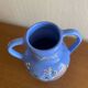 Glazed blue ceramic vase with folk decoration