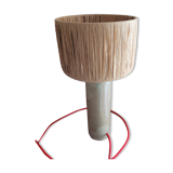 Sandstone lamp with raffia shade