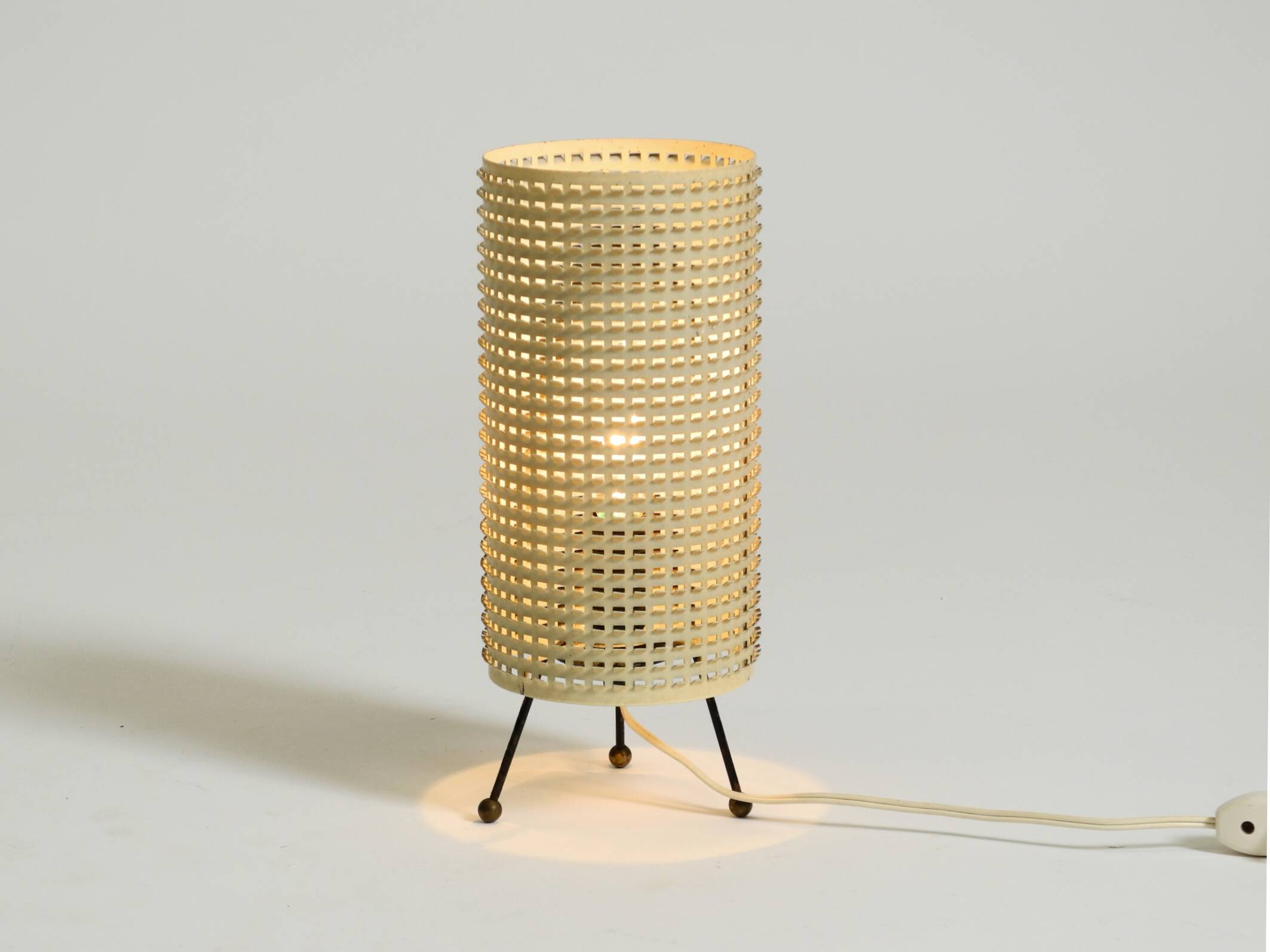 Original 1950s brass tripod table lamp with a perforated metal lampshade