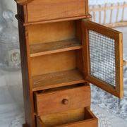 Vintage wooden shelf with drawers and mesh door.