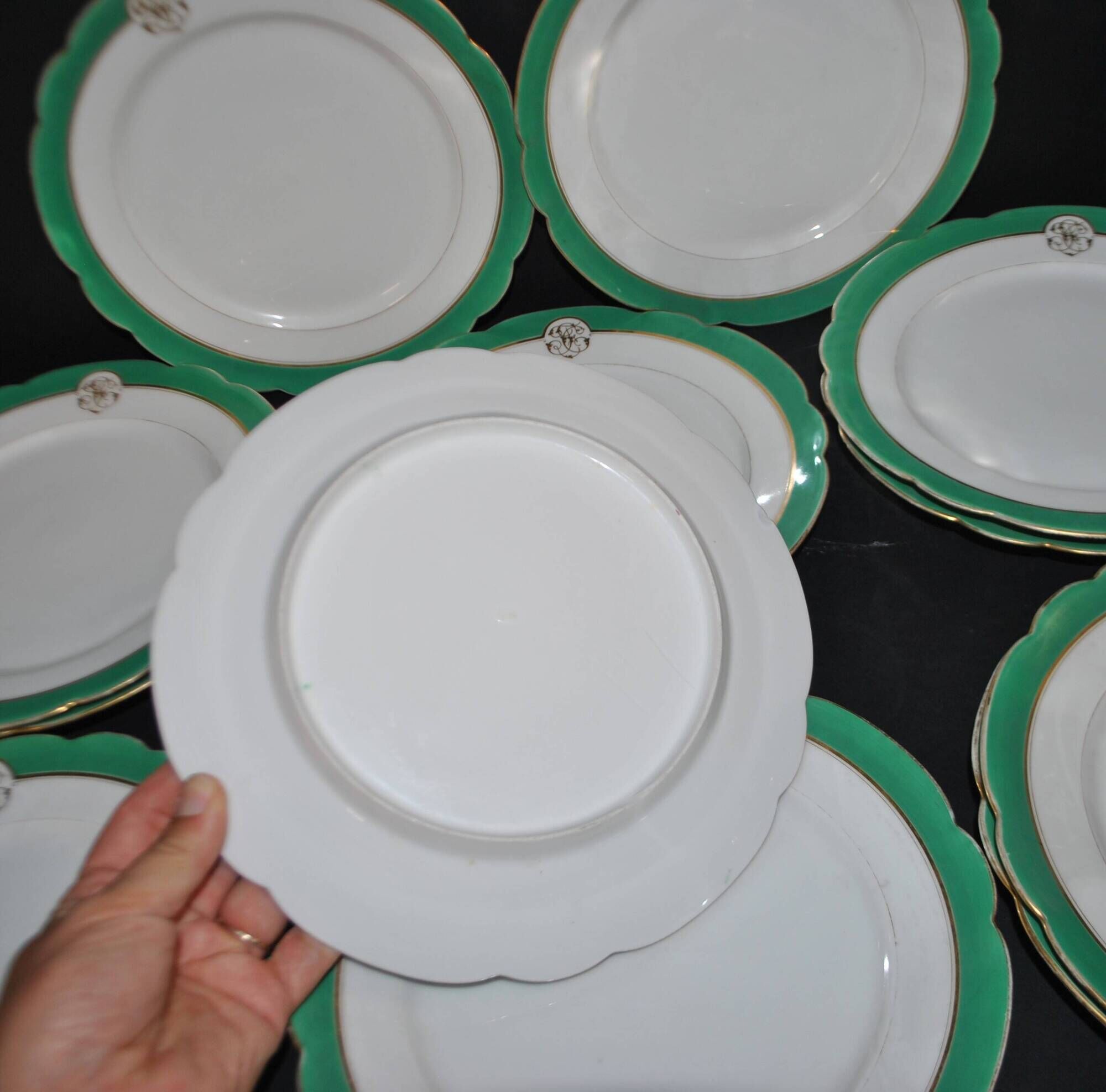 Paris porcelain set of 12 flat plates with green border and gold monogram JC.
