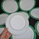 Paris porcelain set of 12 flat plates with green border and gold monogram JC.