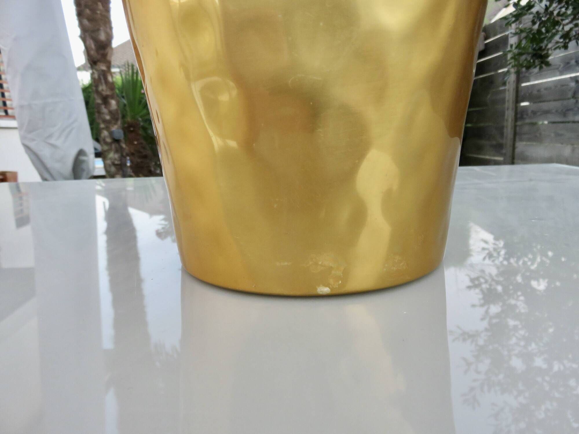 Gold anodised aluminium ice bucket, teak handles, signed T.L PARIS.