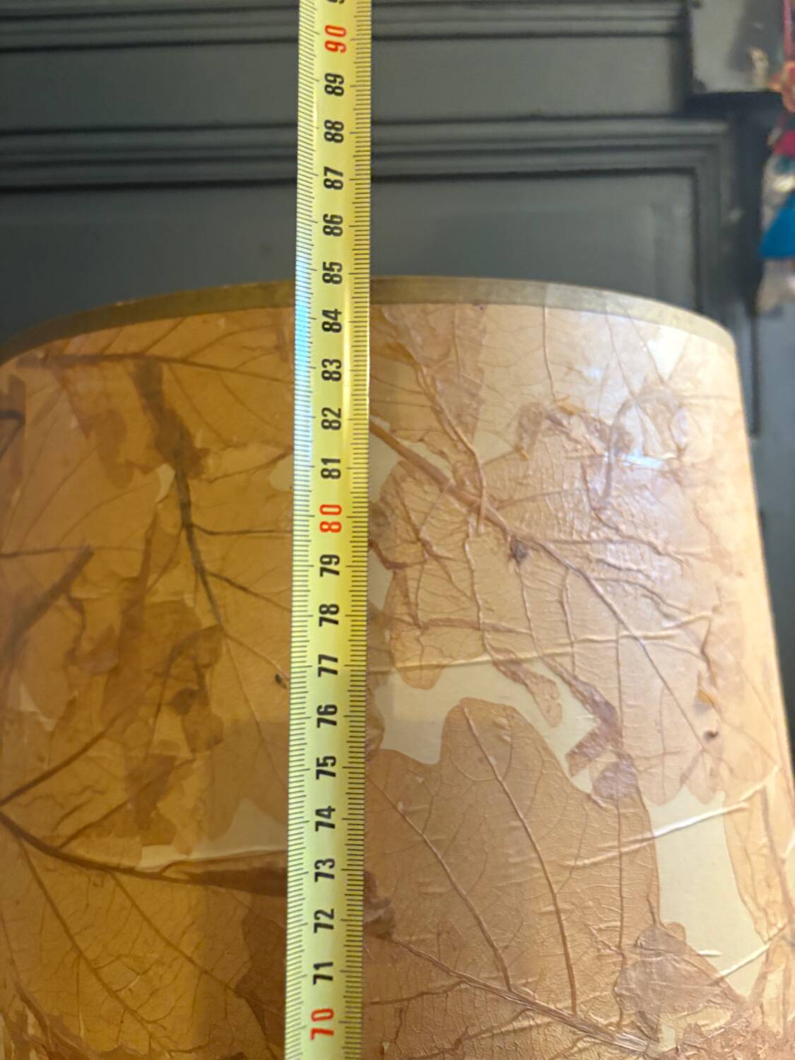 Large beige ceramic table lamp with a vintage shade.