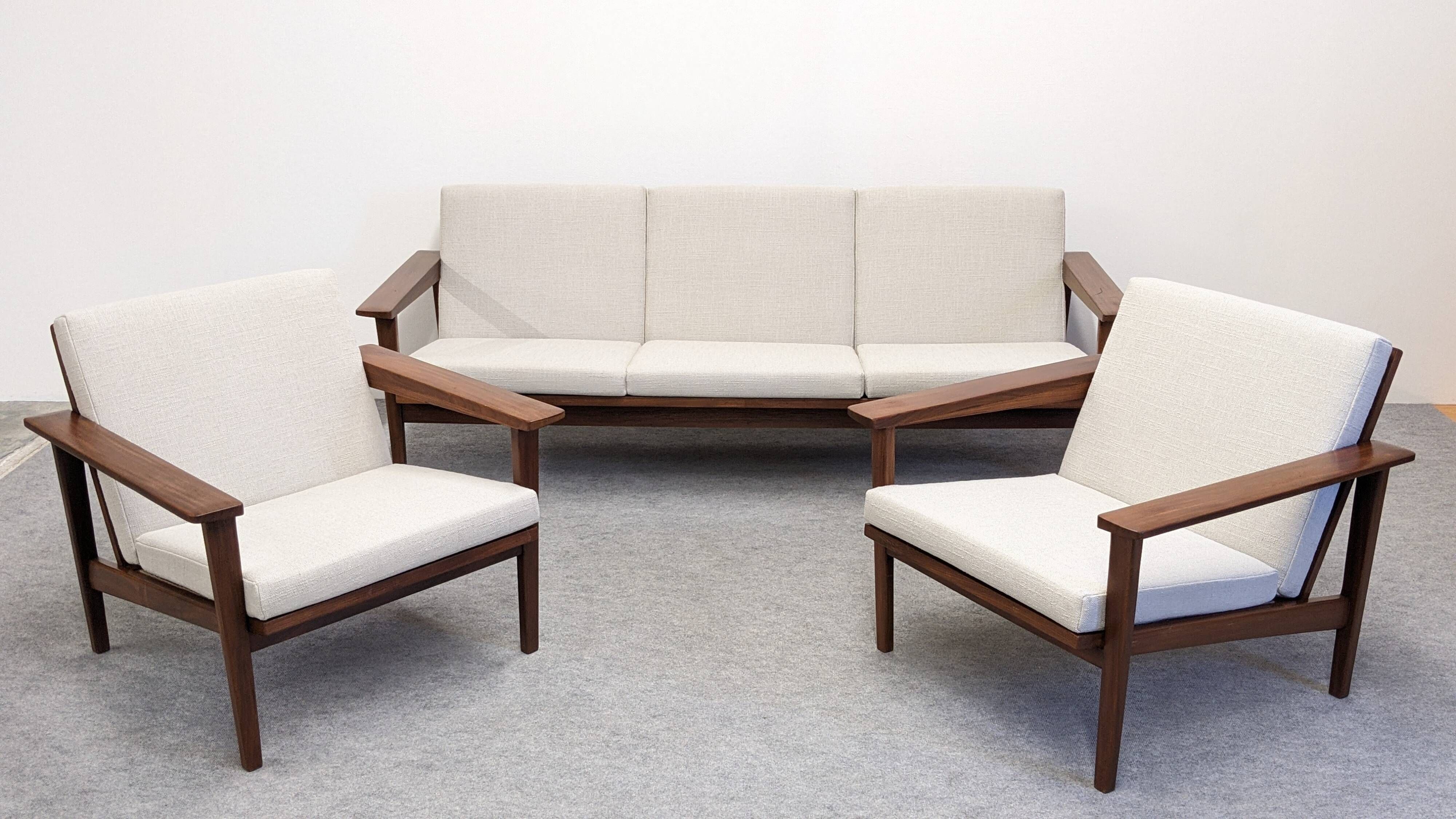Living room, three-seater sofa and two armchairs, modernist in teak, France around 1950.