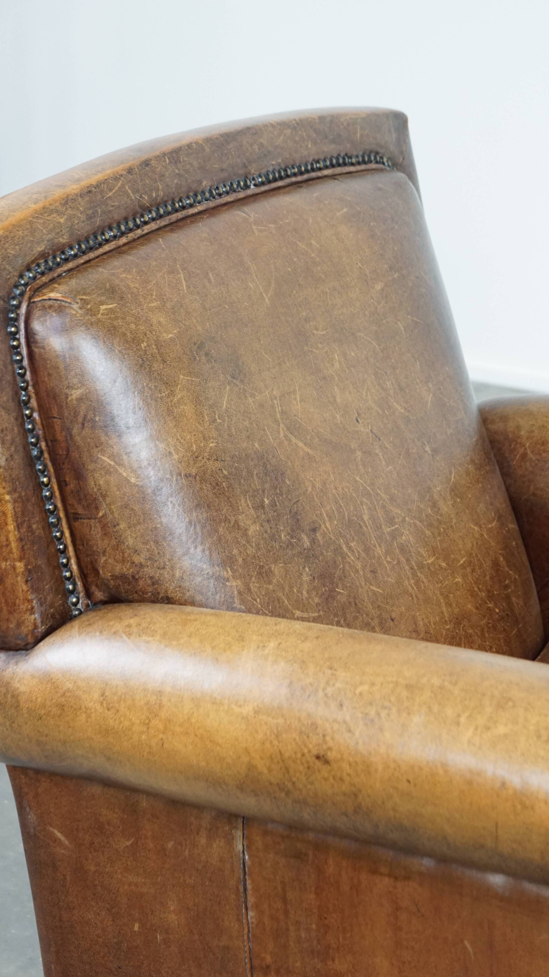 Armchair made of sheep leather finished with decorative nails