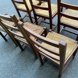 6 light solid wood chairs with high straw backs, farmhouse style.