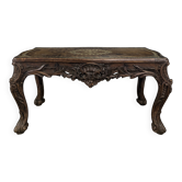 Louis XV coffee table in carved walnut with a gilded leather top.
