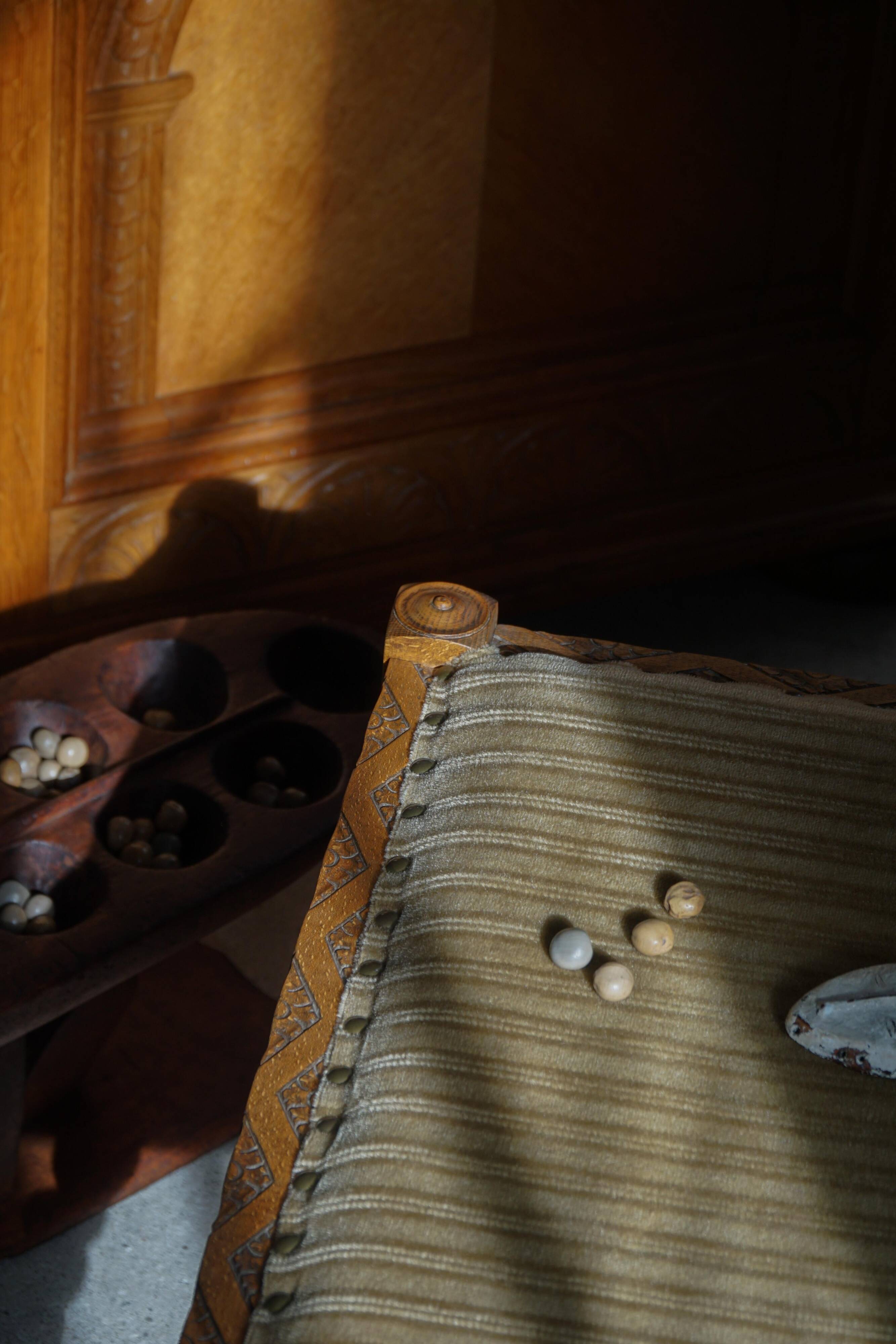 Decorative Mancala game board made of hand-carved wood, Africa, mid-20th century.