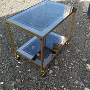 Vintage golden metal rolling dessert trolley