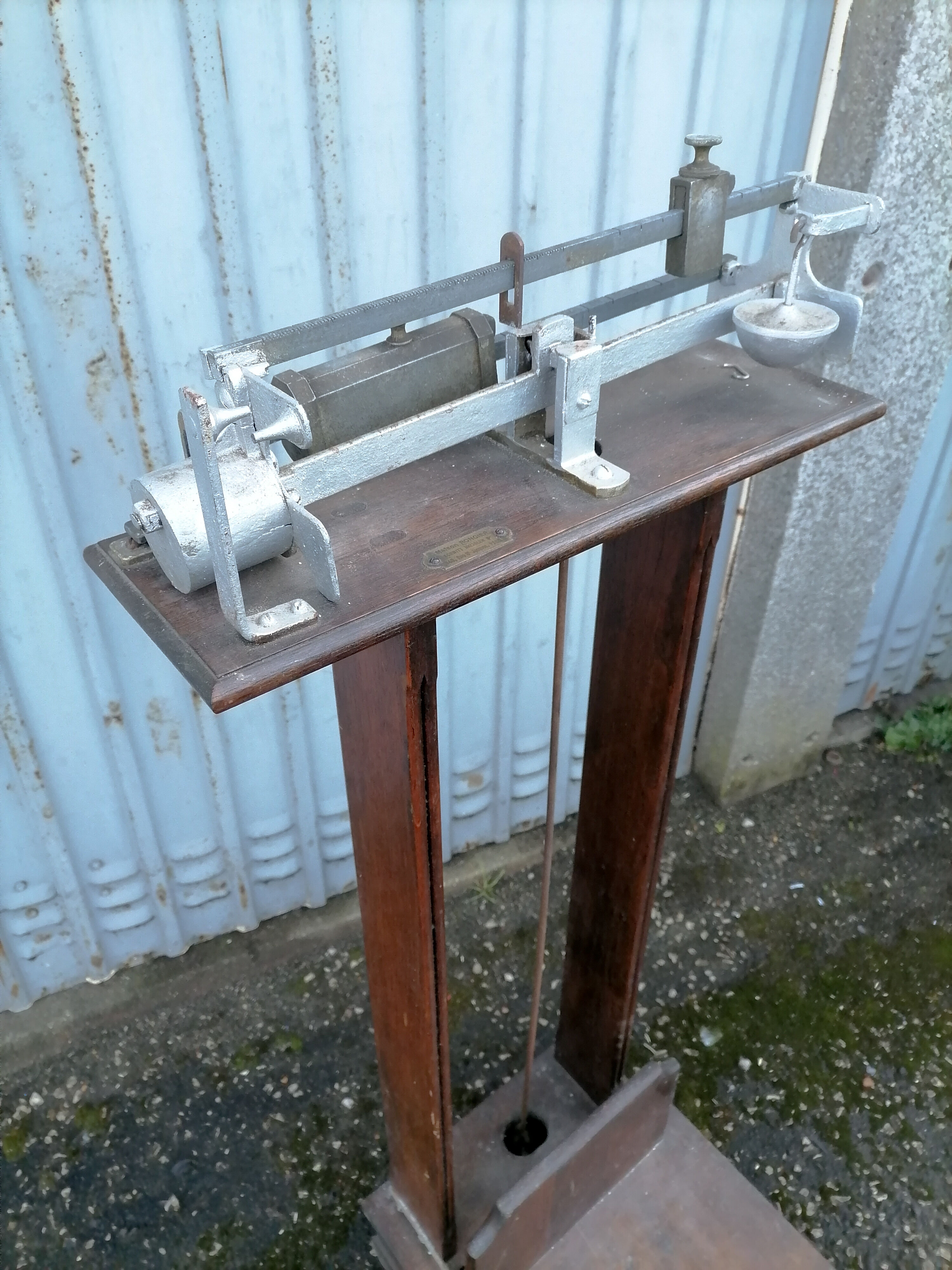 Old scale at pharmacy wood house rongier weighs person