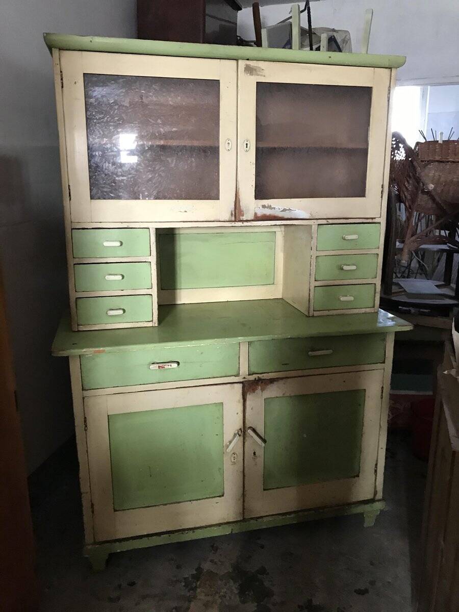 Vintage wooden kitchen cupboard painted green and beige, with glass doors - 1930s