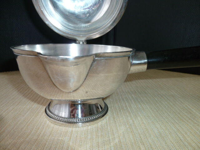 Covered saucepan with silver metal tail