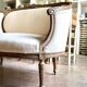Two-seater basket bench in carved wood and beige mixed fabric, 18th century.