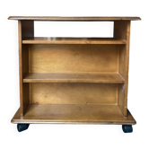 Louis Philippe style bookcase on wheels made of varnished solid wood.