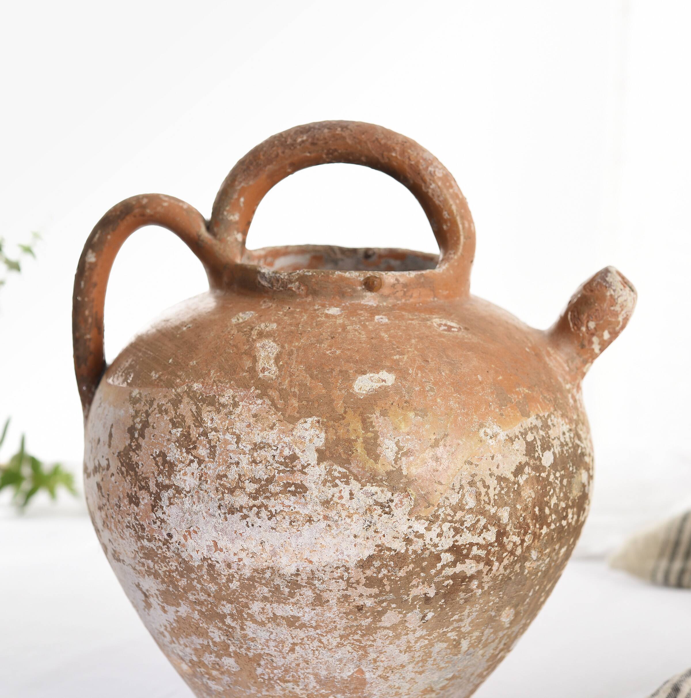 Old water jug. Gargoulette. Old terracotta pitcher.