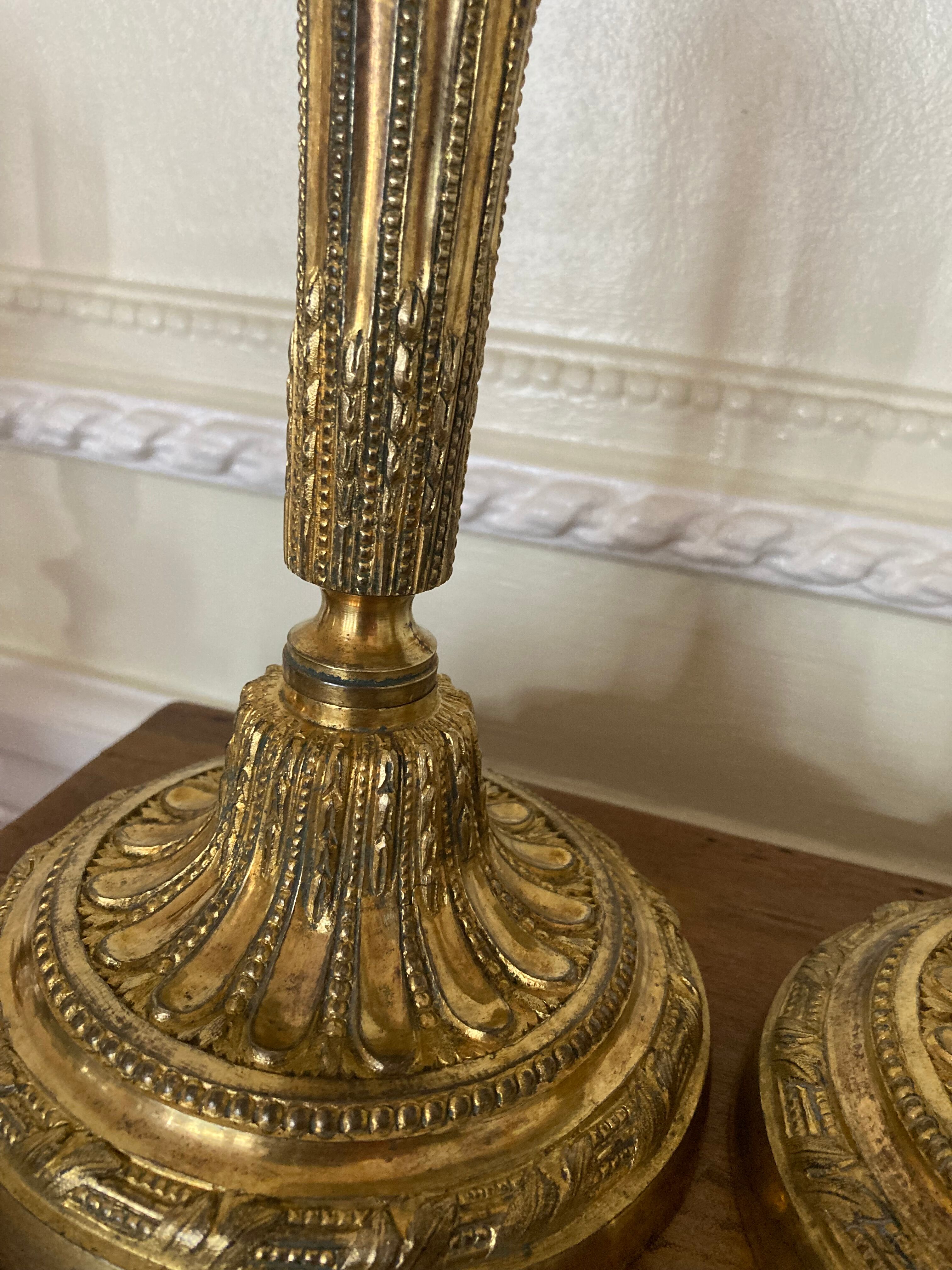 Pair of Louis XVI torch candlesticks in gilded bronze