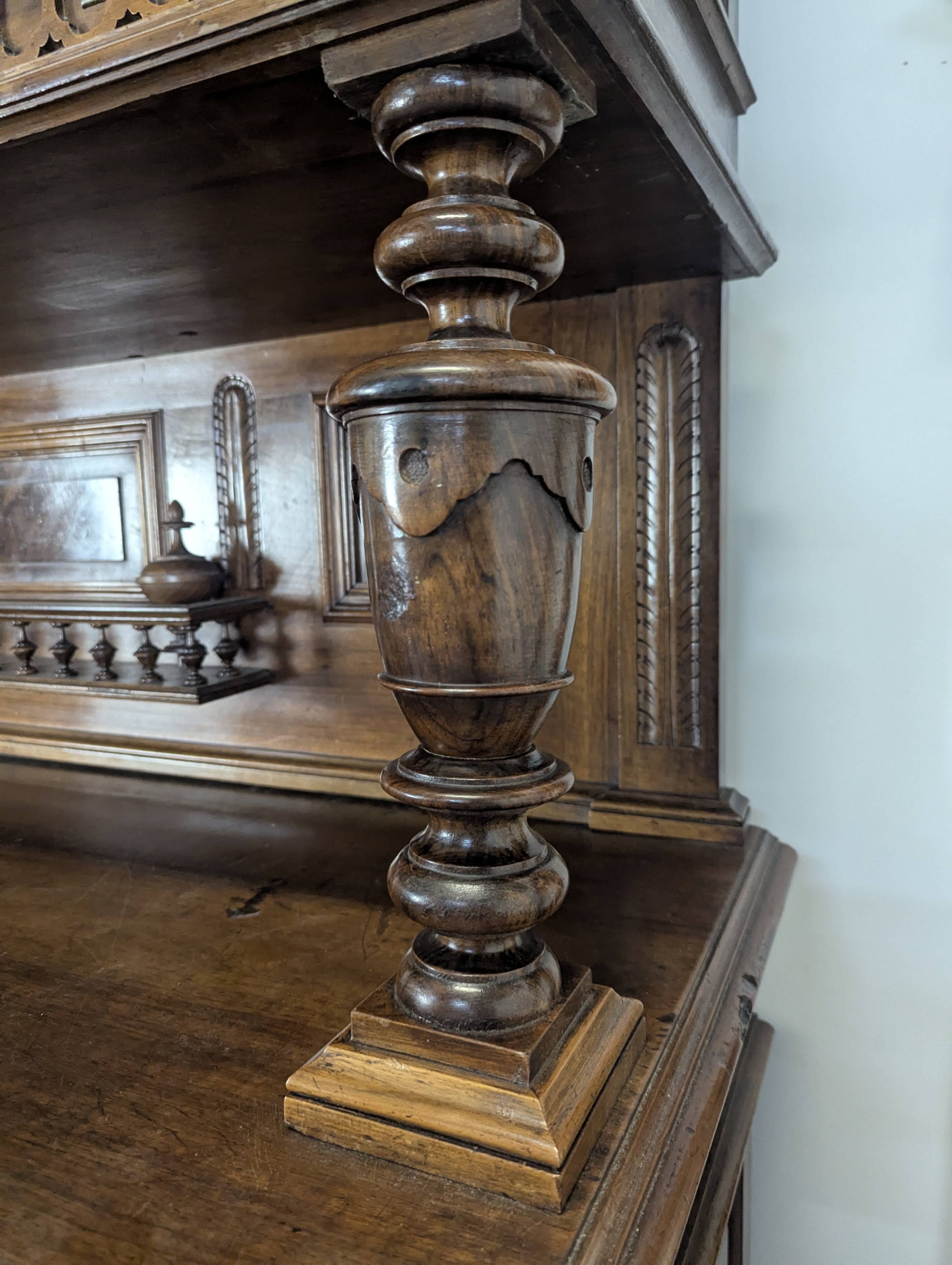 Large buffet with 2 bodies in Renaissance style made of solid walnut.