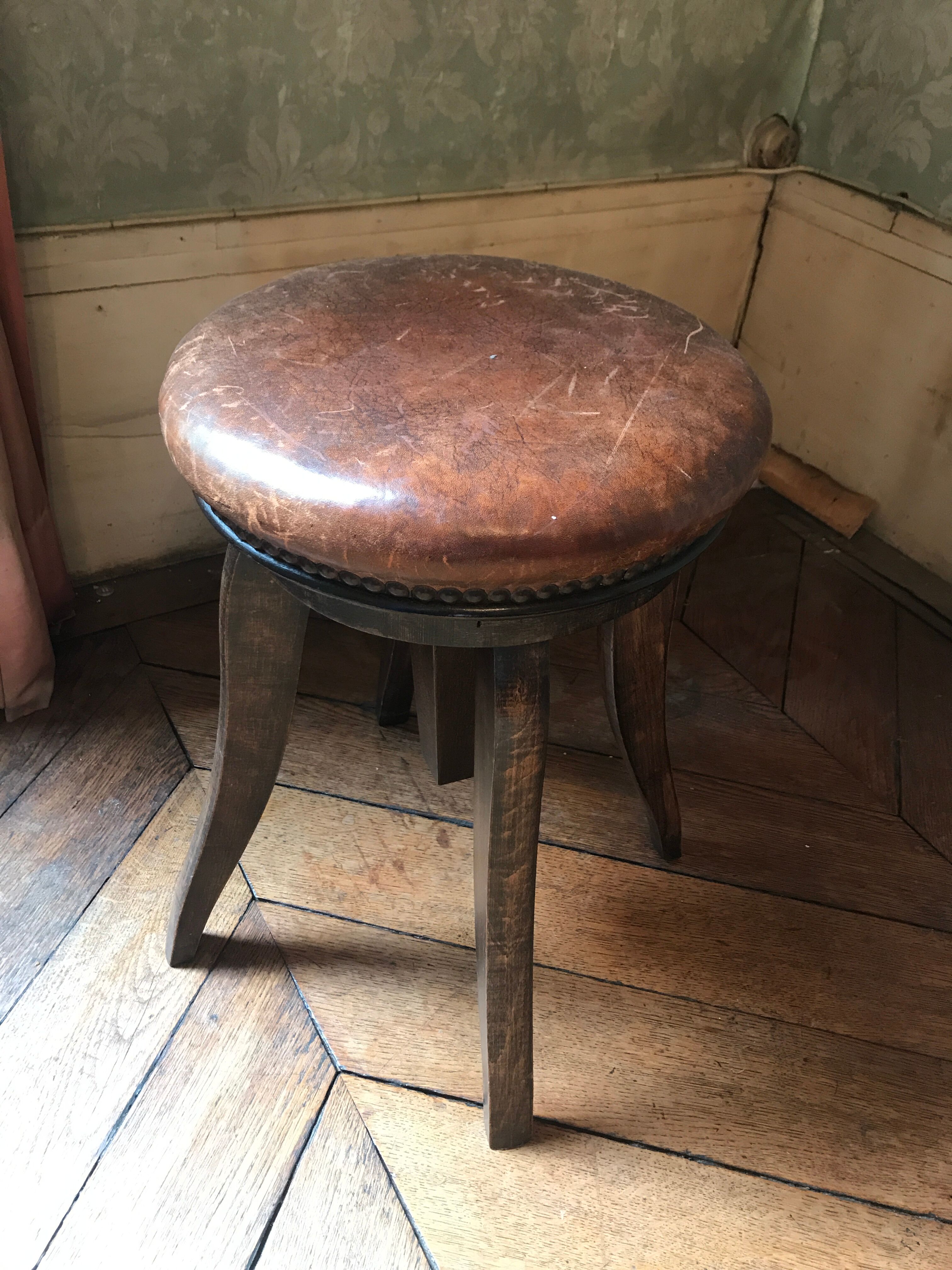 Old leather rotating piano stool