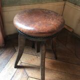 Old leather rotating piano stool