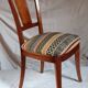 2 varnished solid wood chairs with "ethnic" padding