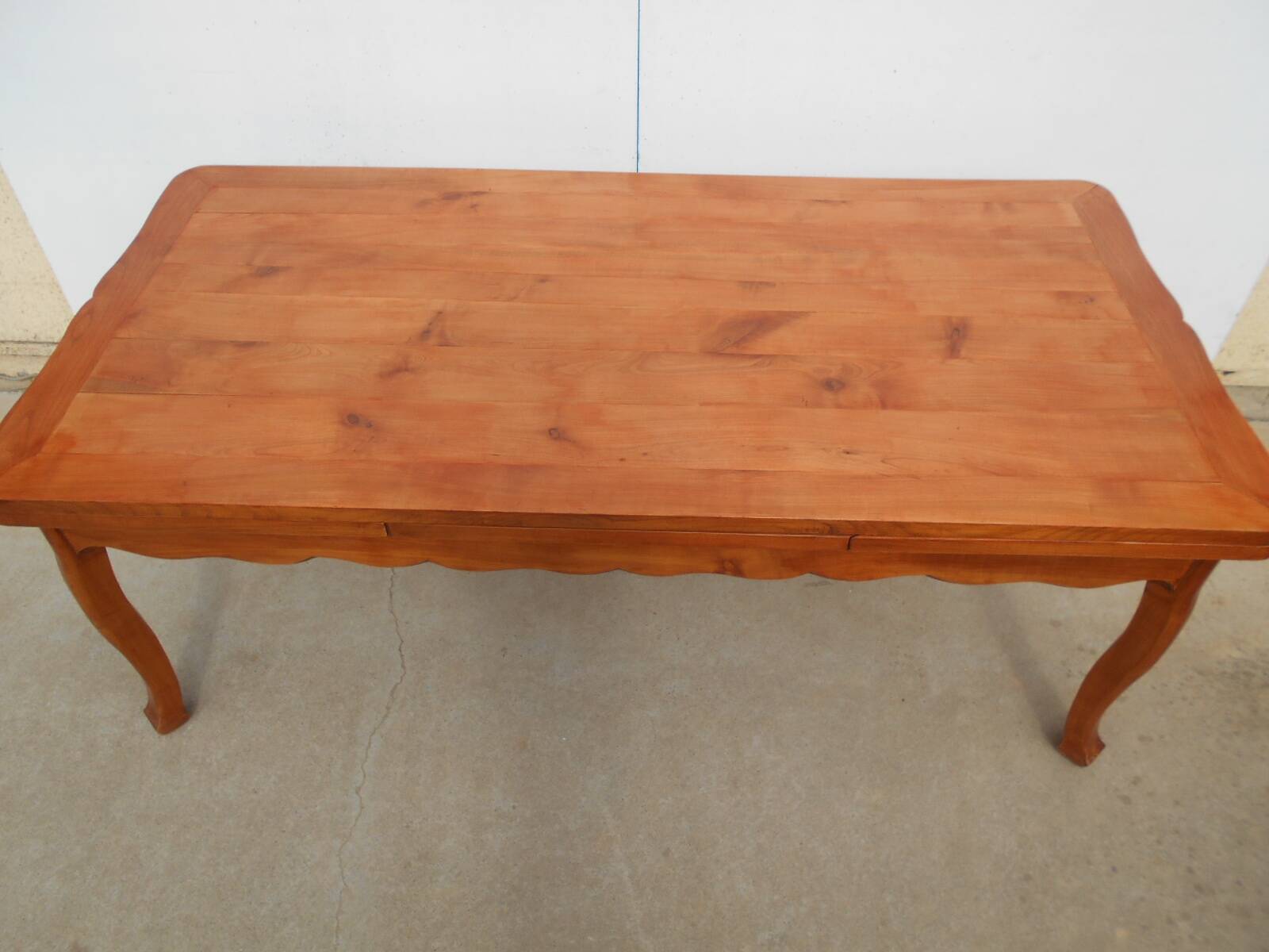 Large solid wood table with integrated extensions.