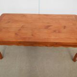 Large solid wood table with integrated extensions.