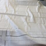 Old white tablecloth in thread with tangles of embroidered days central monogram